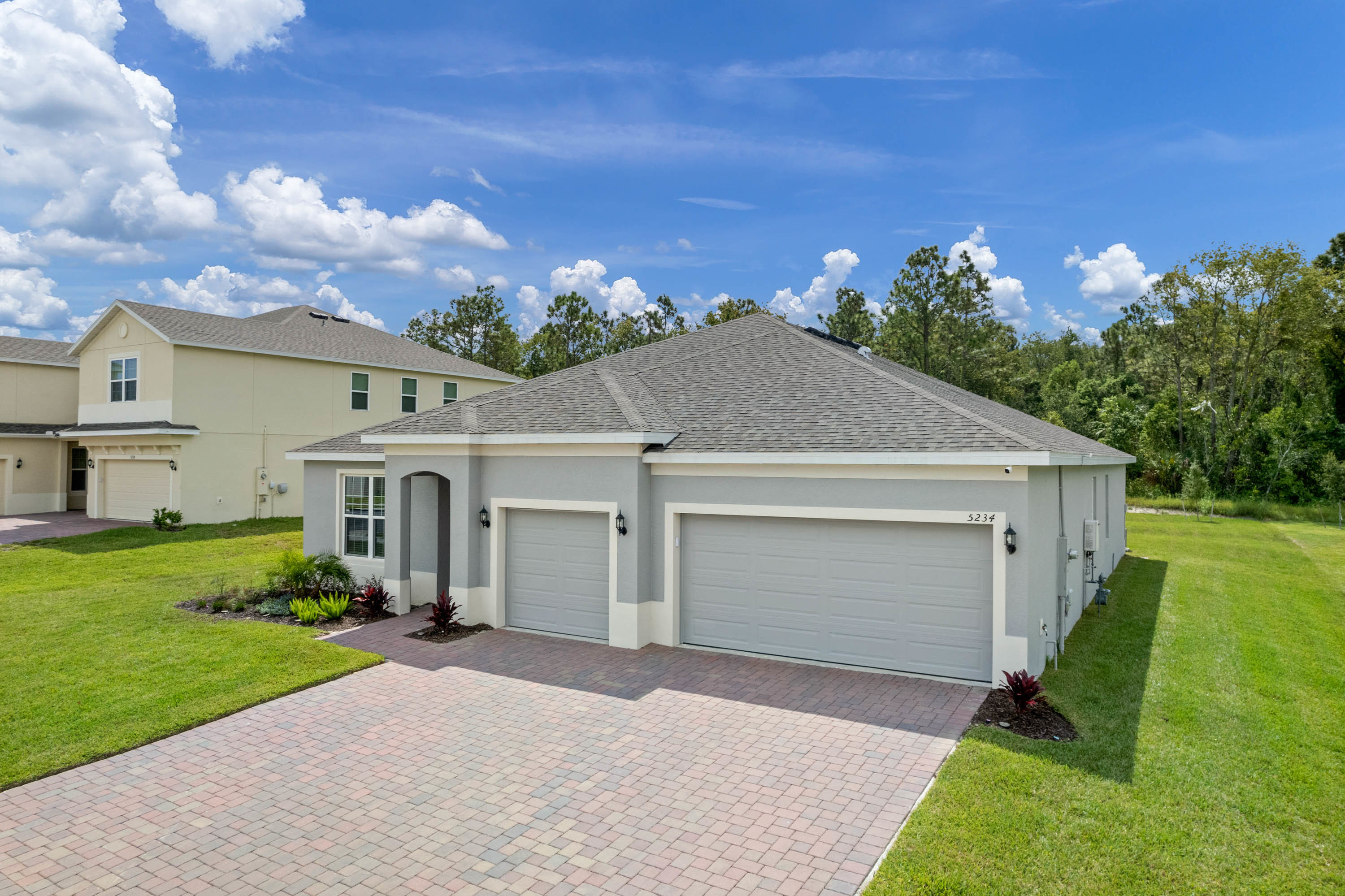 front view of one story new construction home with light blue paint
