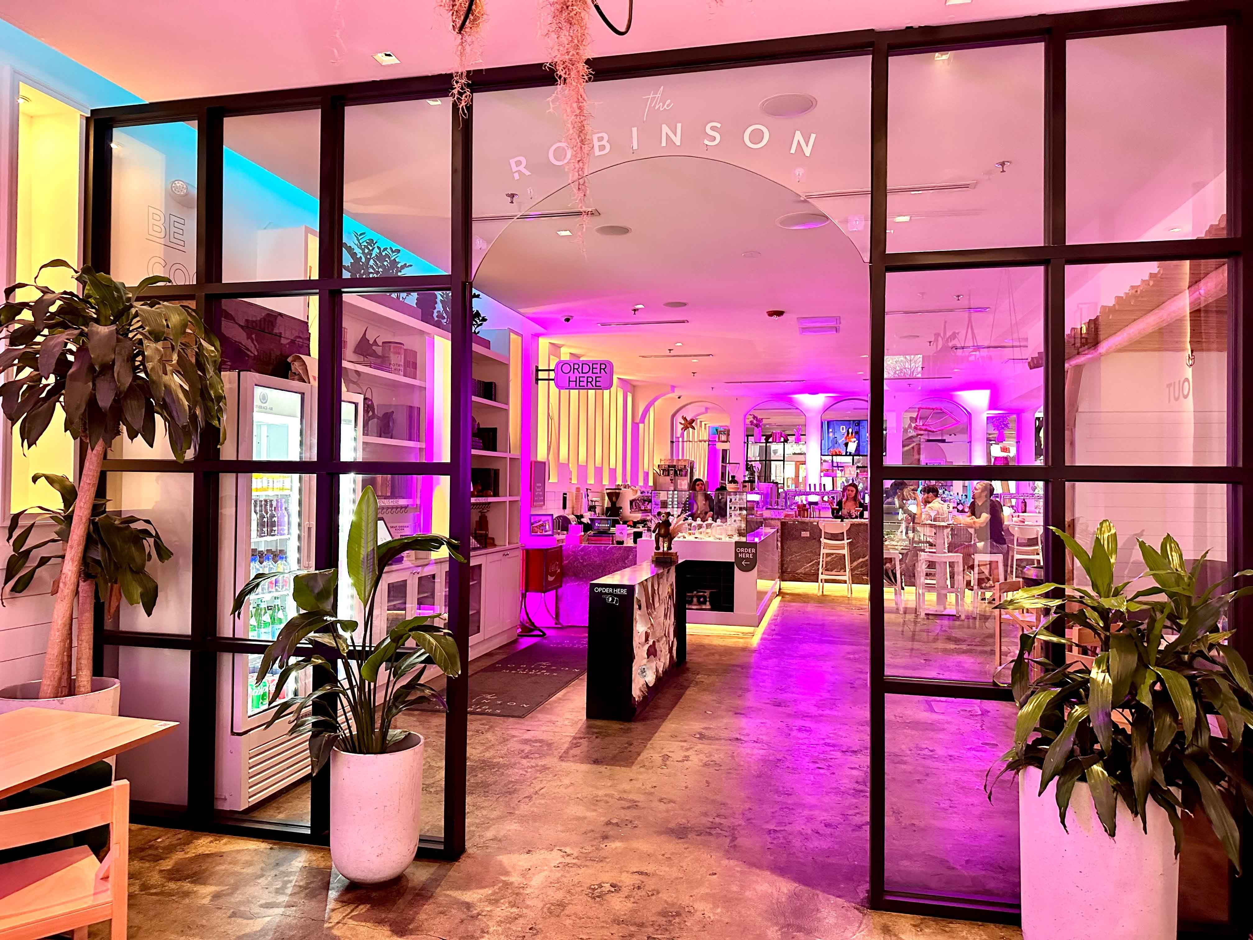 black window frame inside a large room with white decor and plants