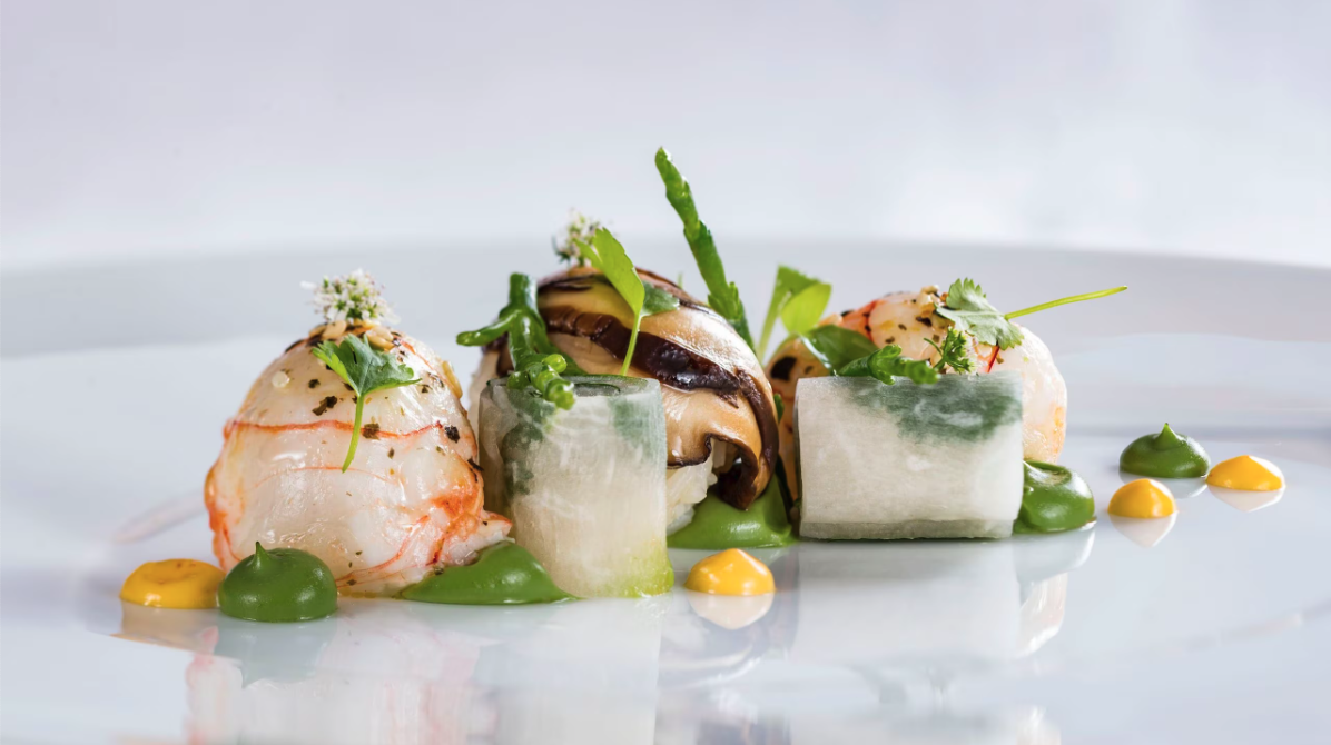 white plate with green and yellow sauces on seafood