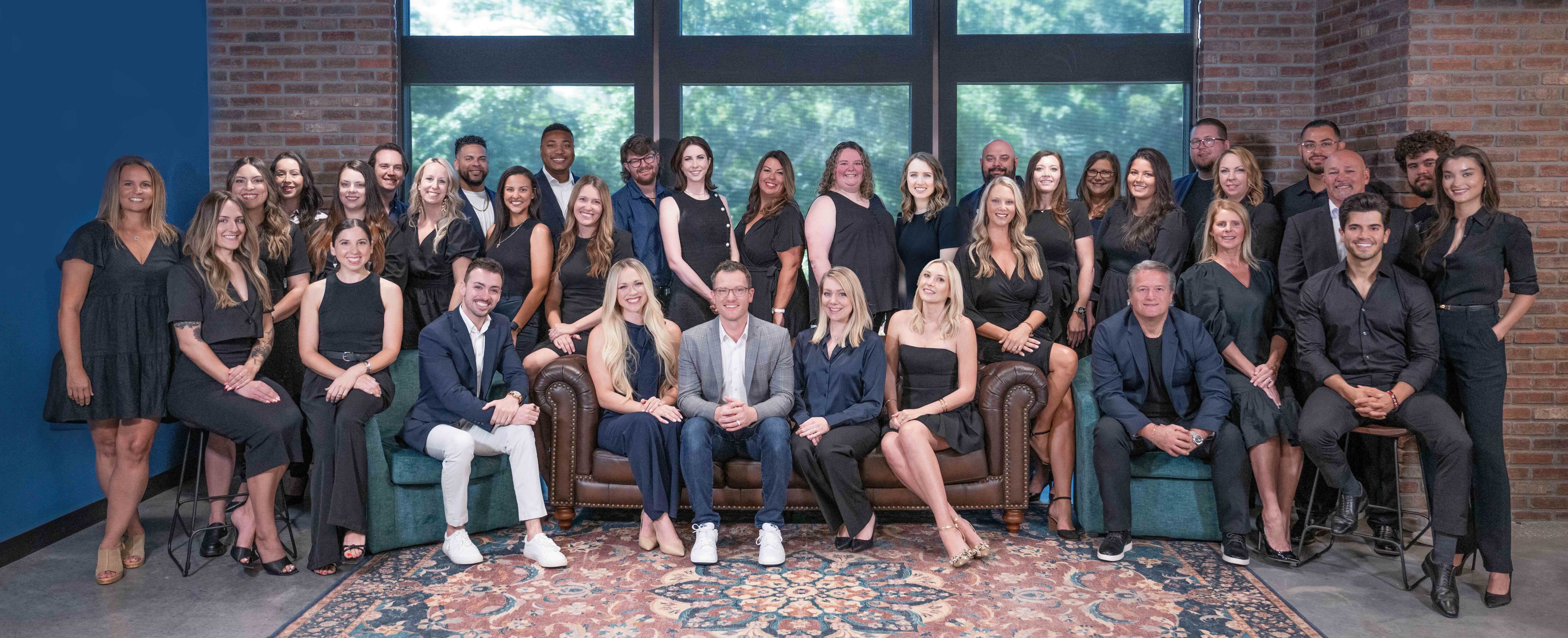 team photo in front of a large window