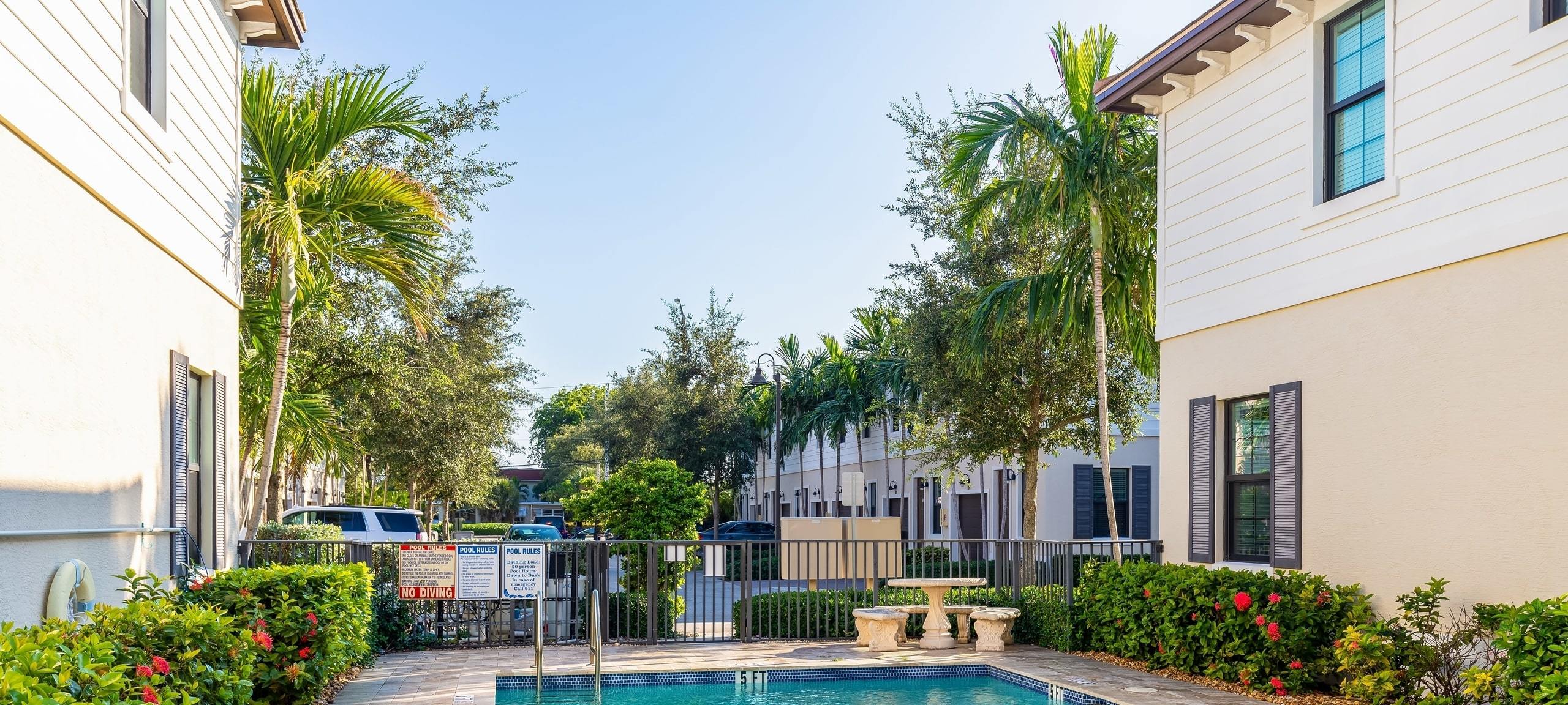 Greater Orlando Area street view with two small condo buildings on each side and center pool