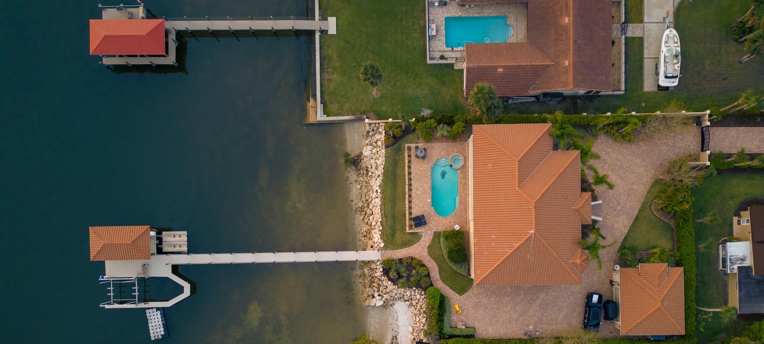 Aerial view of luxury homes with private, lakefront docks and swimming pools