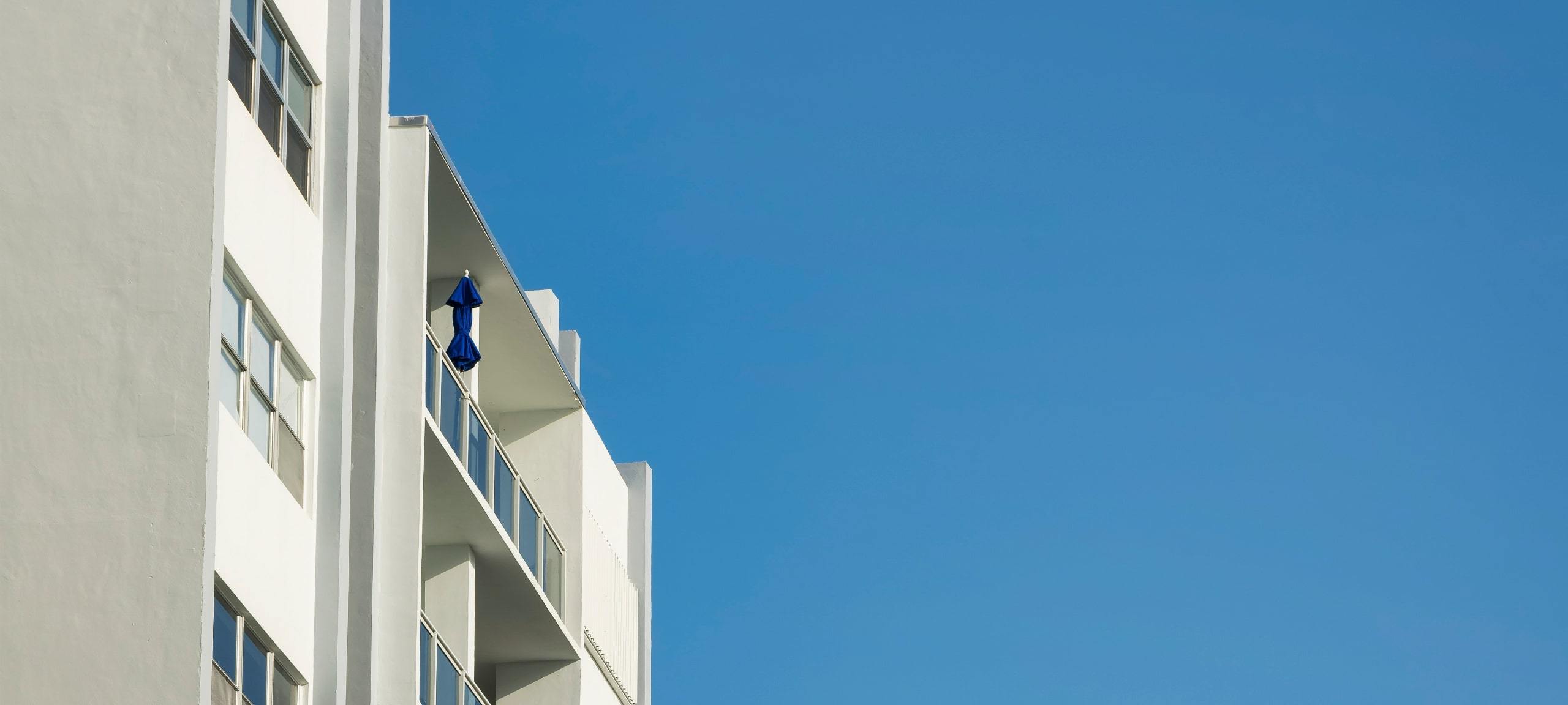 Exterior of white concrete condo building, typical of College Park, Orlando