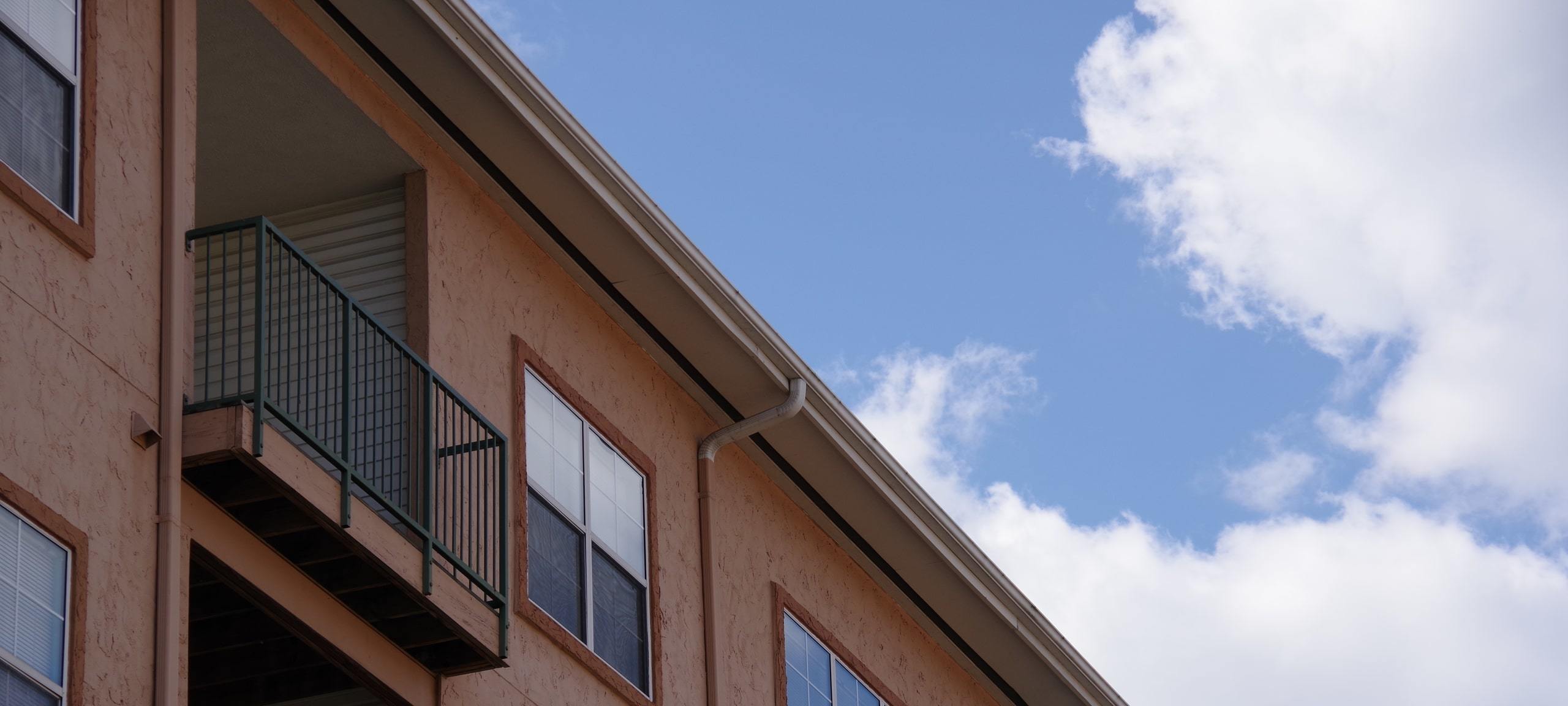 Upwards view of Mediterranean style condo building, typical of Hunters Creek