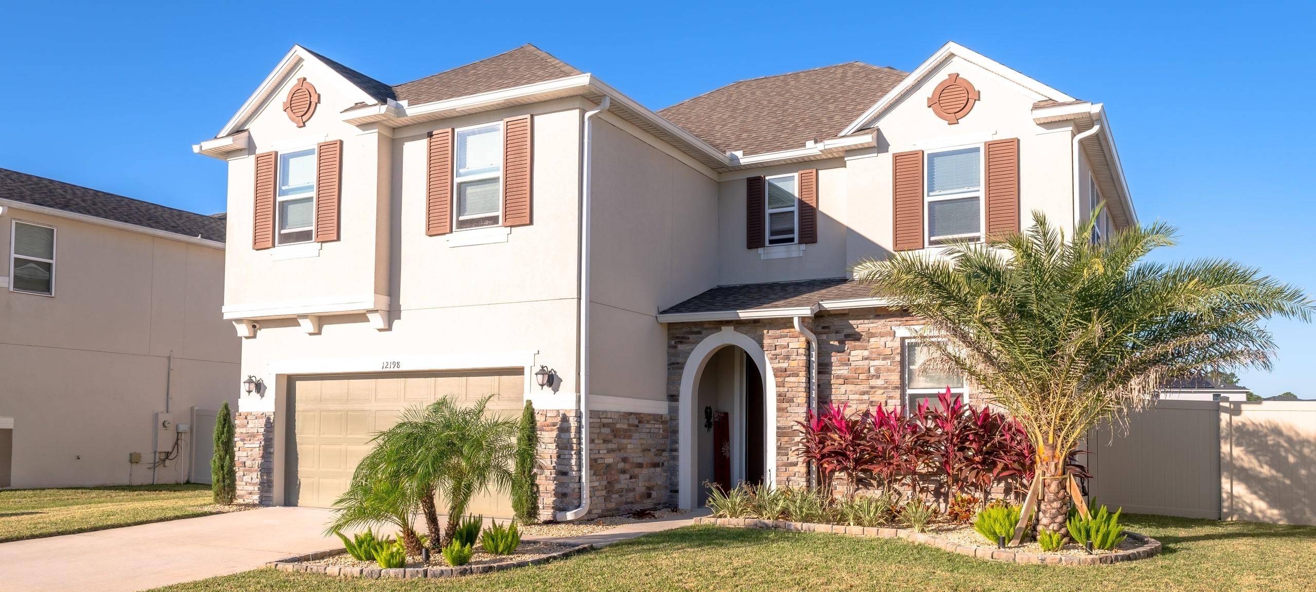 Exterior of large, Mediterranean style home, typical of the Orlando area
