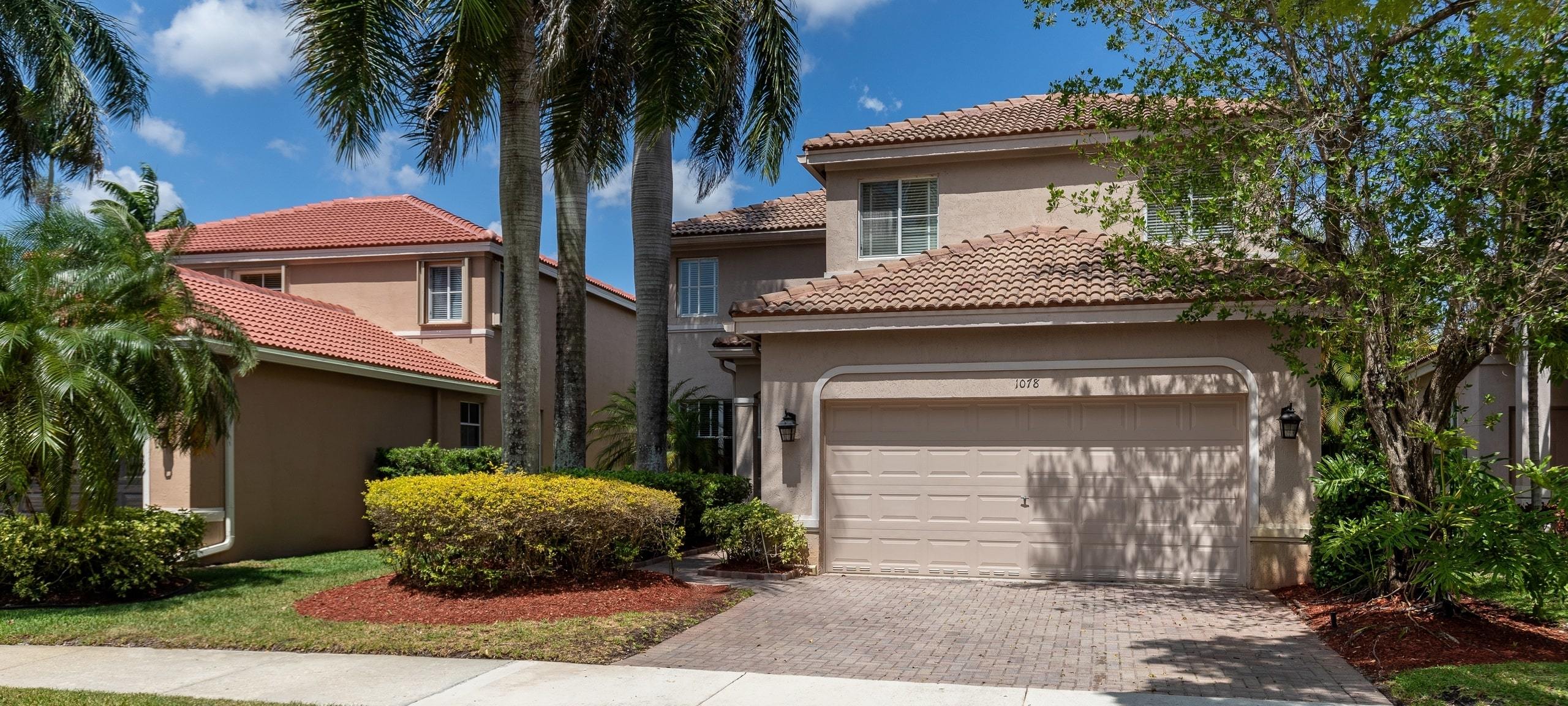 Exterior of two Mediterranean-style homes in a Florida neighborhood
