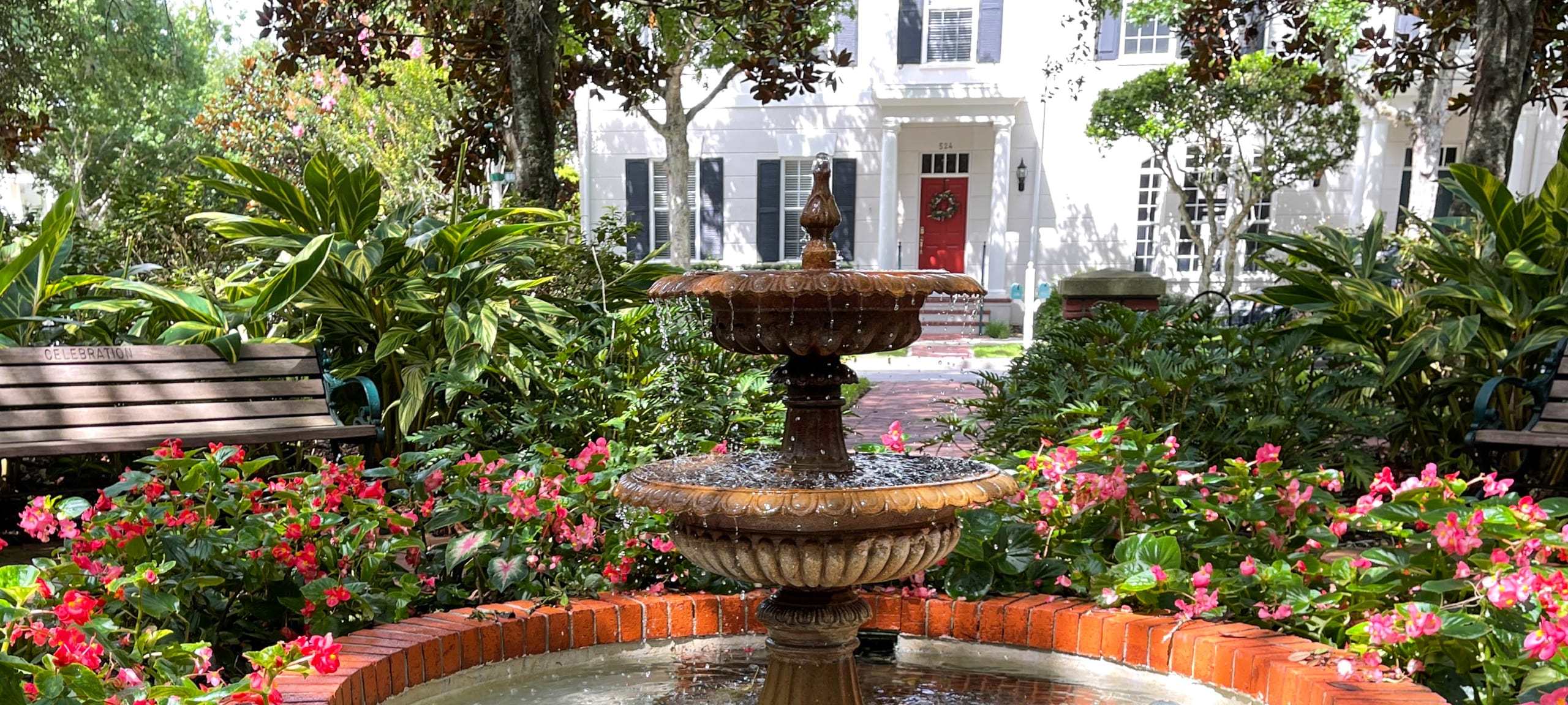 Fountain in front of white single-family home in Orlando, FL neighborhood