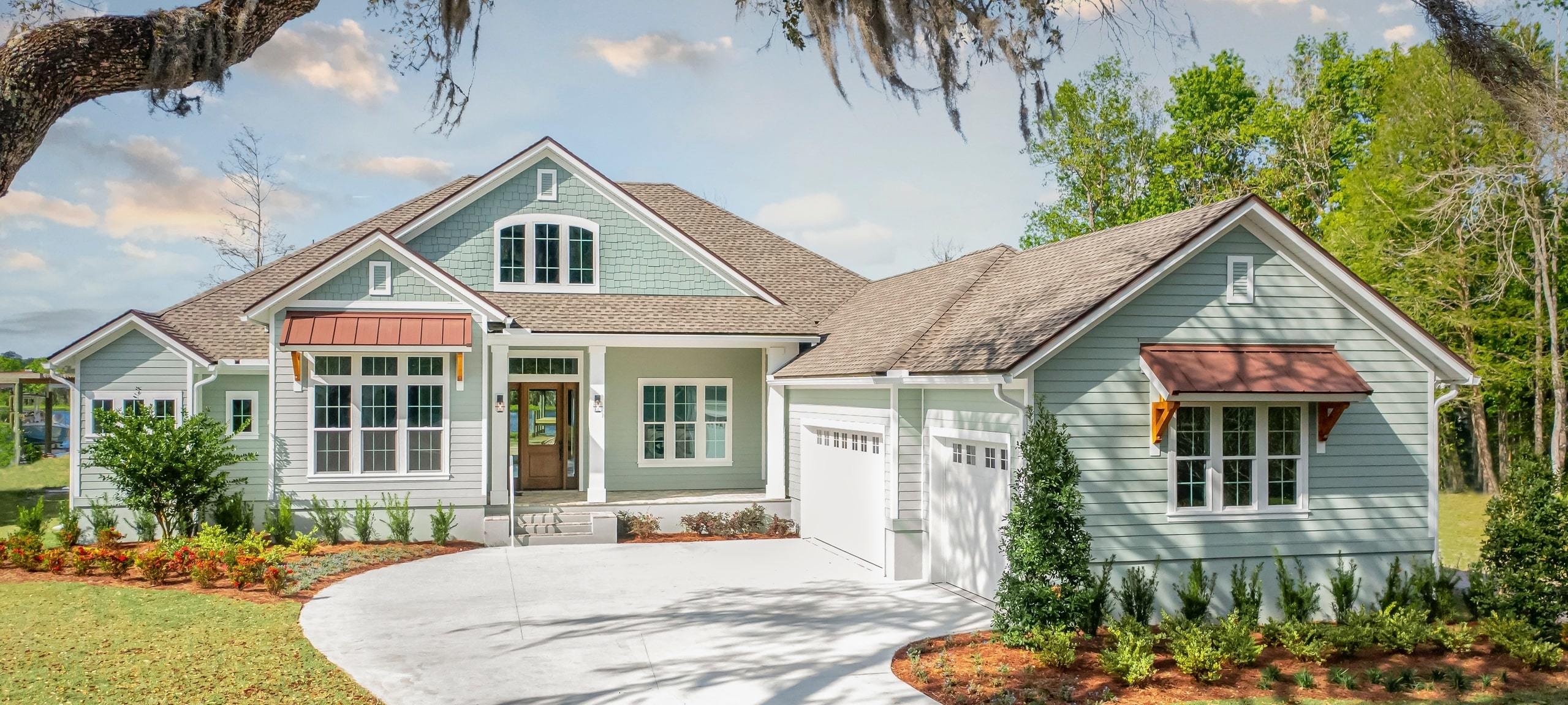 Traditional style home framed by trees in Florida neighborhood