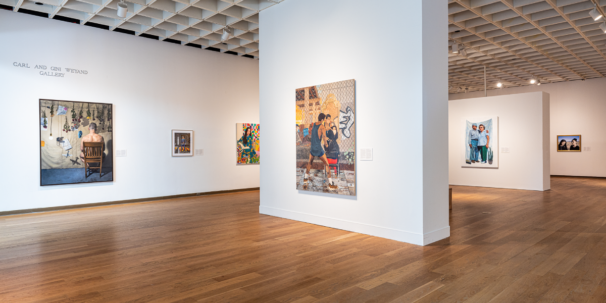 wood flooring and white walls with art hung in frames