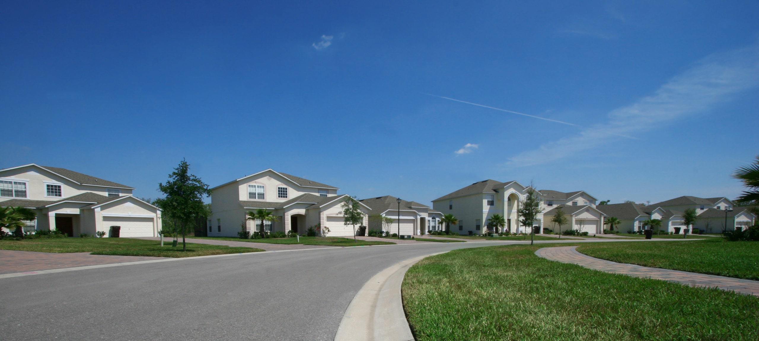 Row of large homes on residential street, typical of Winter Garden, Florida